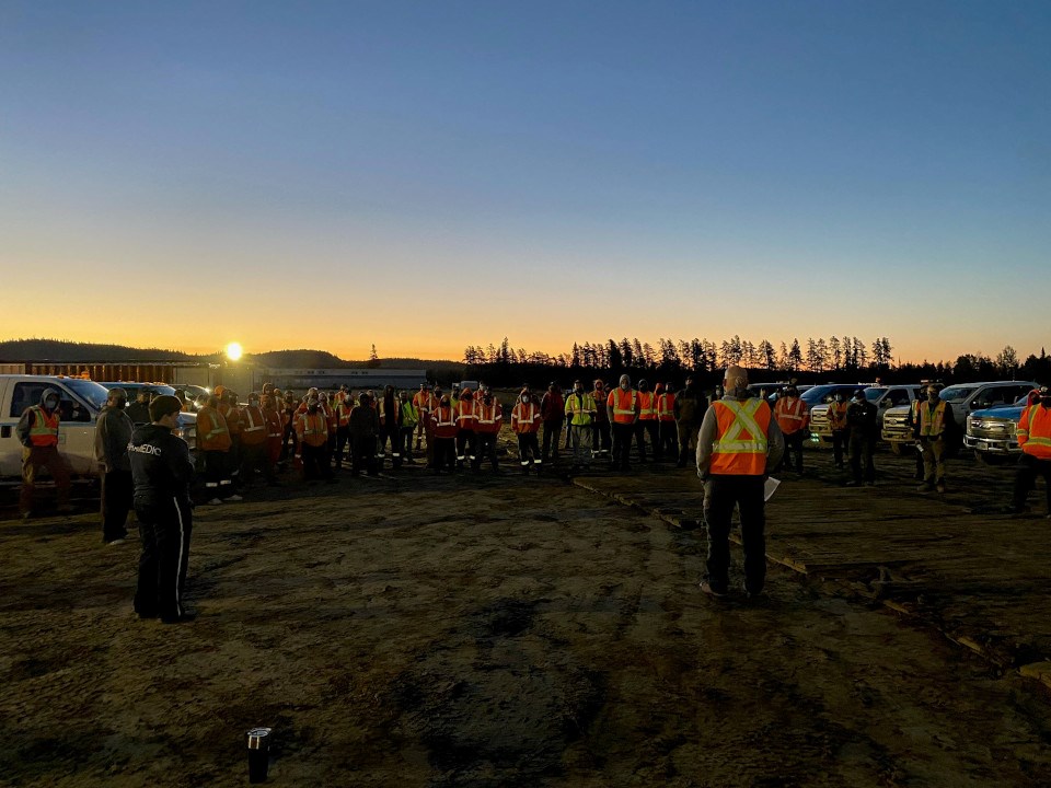 At sunrise on Sept. 30, a Valard Construction crew at its Wawa camp on the East-West Tie transmission line project acknowledges Truth & Reconciliation Day with a somber moment of Stand Down. (Valarde photo)
